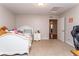 Bright bedroom with cozy carpet, white furniture, and doorway leading to another room at 1665 Avery Way, Castle Rock, CO 80109