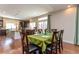 Charming dining area with wood floors, a green tablecloth, and views into the spacious kitchen at 1665 Avery Way, Castle Rock, CO 80109