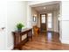 Welcoming foyer featuring wood floors, a console table with plant, and a wooden bench at 1665 Avery Way, Castle Rock, CO 80109