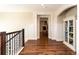 Upstairs hallway features hardwood floors, elegant trim, and access to other rooms at 1665 Avery Way, Castle Rock, CO 80109