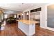 Open concept kitchen featuring a granite-topped island, stainless steel appliances, and hardwood floors at 1665 Avery Way, Castle Rock, CO 80109