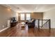Bright living room features hardwood floors, tray ceiling and a leather seating area at 1665 Avery Way, Castle Rock, CO 80109