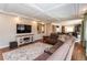 Inviting living room features wood floors, a sectional sofa, and an open layout at 1665 Avery Way, Castle Rock, CO 80109