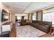 Comfortable living room with a large sectional, tray ceiling, and open floor plan at 1665 Avery Way, Castle Rock, CO 80109