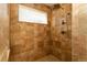Tiled shower with adjustable shower head and built-in seat, perfect for relaxation at 1665 Avery Way, Castle Rock, CO 80109