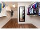Spacious walk-in closet with hardwood floors, wall mirror, shelving, and ample storage space for clothing at 1665 Avery Way, Castle Rock, CO 80109