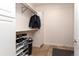 Organized walk-in closet with shelving, hanging rods, and neutral decor at 1665 Avery Way, Castle Rock, CO 80109