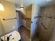Bathroom featuring a shower, vanity, and toilet with a linen closet space at 7021 Saulsbury St, Arvada, CO 80003