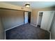 Bedroom with neutral walls, carpeted floors, closet, and a window for natural light at 7021 Saulsbury St, Arvada, CO 80003