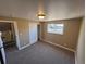 Bedroom featuring neutral walls, carpeted floors, closet, and a window providing natural light at 7021 Saulsbury St, Arvada, CO 80003