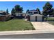Charming two-story home featuring a two-car garage and a well-maintained front yard at 7021 Saulsbury St, Arvada, CO 80003