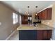 Updated kitchen with stainless steel appliances, granite countertops, and modern pendant lighting at 7021 Saulsbury St, Arvada, CO 80003