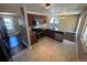 Bright kitchen with granite countertops, stainless steel appliances, and a view into the dining area at 7021 Saulsbury St, Arvada, CO 80003