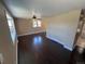 Spacious living room with dark hardwood floors, neutral paint, and natural light from multiple windows at 7021 Saulsbury St, Arvada, CO 80003