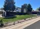 Exterior side view of a well-maintained house with a green lawn, fencing, and a chimney at 7021 Saulsbury St, Arvada, CO 80003