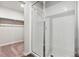 Bright bathroom features a glass-enclosed shower, a walk-in closet, and tiled walls at 1399 Orchard St, Brighton, CO 80601