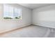 Bright bedroom features a window for natural light, light-colored walls and neutral carpet at 1399 Orchard St, Brighton, CO 80601