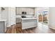 Bright kitchen with white cabinets, an island, and stainless appliances, perfect for cooking and gathering with loved ones at 1399 Orchard St, Brighton, CO 80601