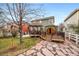 Large backyard featuring a deck with gazebo, cedar sauna, stone patio, and green lawn at 23662 E Alabama Dr, Aurora, CO 80018