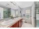 Bright bathroom featuring a double sink vanity with wood cabinets and tile floors at 23662 E Alabama Dr, Aurora, CO 80018