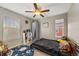 Comfortable bedroom with natural light from two windows and a ceiling fan at 23662 E Alabama Dr, Aurora, CO 80018