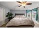Well-lit primary bedroom features a ceiling fan, neutral walls, and curtains at 23662 E Alabama Dr, Aurora, CO 80018