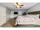Comfortable primary bedroom features neutral walls, ceiling fan, and plush carpet at 23662 E Alabama Dr, Aurora, CO 80018