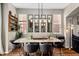 Elegant dining area features a marble table, unique light fixtures, and a set of mirrors at 23662 E Alabama Dr, Aurora, CO 80018