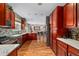 Spacious kitchen with wooden cabinets, marble countertops, stainless steel appliances and wood floors at 23662 E Alabama Dr, Aurora, CO 80018