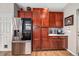 Kitchen with stainless steel appliances, wood cabinets, and a marble countertop at 23662 E Alabama Dr, Aurora, CO 80018