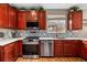 Well-lit kitchen features stainless steel appliances, custom backsplash, and wood-look floors at 23662 E Alabama Dr, Aurora, CO 80018