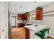 Well-lit kitchen with a breakfast bar, marble countertops, and wood cabinets at 23662 E Alabama Dr, Aurora, CO 80018