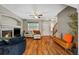 Inviting living area with hardwood floors, a fireplace, and access to the front entry and stairs at 23662 E Alabama Dr, Aurora, CO 80018