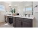 Bright bathroom featuring a double vanity with quartz countertops, modern fixtures, and a large mirror at 2515 Clayton Cir, Superior, CO 80027