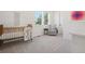 Bedroom featuring a crib, glider, and large windows at 2515 Clayton Cir, Superior, CO 80027