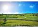 Scenic view of a winding path through a green community area under a bright, clear sky with distant homes visible at 2515 Clayton Cir, Superior, CO 80027