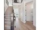 Bright foyer with wood floors, staircase, and a glimpse into the living room and adjacent bathroom at 2515 Clayton Cir, Superior, CO 80027