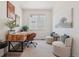 Bright home office with a rustic wood desk, accent chairs, and modern decor at 2515 Clayton Cir, Superior, CO 80027