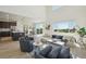 Bright, open-concept living space featuring a fireplace, modern furnishings, and an adjacent kitchen and dining area at 2515 Clayton Cir, Superior, CO 80027
