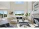 Spacious and luminous living room with a view of the outdoor scenery, stone fireplace, and modern furniture arrangement at 2515 Clayton Cir, Superior, CO 80027