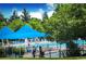 Community pool area with blue shade structures, lounge chairs, and mature trees at 2515 Clayton Cir, Superior, CO 80027