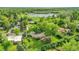 Aerial view of a charming home nestled in a lush, green neighborhood with mature trees and a nearby lake at 595 W Lake Ave, Littleton, CO 80120