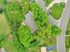 Aerial view of a home with mature trees and landscaping, nestled on a quiet street in a lush neighborhood at 595 W Lake Ave, Littleton, CO 80120
