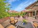 Inviting backyard patio with multiple seating areas and umbrellas for shade, ideal for outdoor relaxation at 595 W Lake Ave, Littleton, CO 80120