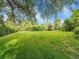 Lush backyard with mature trees offering shade and privacy, creating a serene outdoor space at 595 W Lake Ave, Littleton, CO 80120