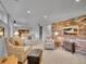 Finished basement with brick accent wall, neutral carpet, and comfortable seating at 595 W Lake Ave, Littleton, CO 80120