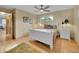 Cozy bedroom with a white bed frame, hardwood floors, and natural light at 595 W Lake Ave, Littleton, CO 80120