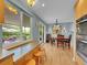 Charming dining room adjacent to kitchen with bright window overlooking private patio at 595 W Lake Ave, Littleton, CO 80120