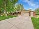 Well-maintained single-Gathering home with brick accents, attached garage, and mature trees at 595 W Lake Ave, Littleton, CO 80120