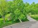 Beautiful home with mature trees in the front yard, complemented by landscaping and a well-maintained lawn at 595 W Lake Ave, Littleton, CO 80120